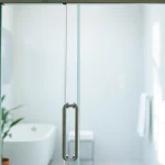Showcase of stylish shower doors sliding, emphasizing sleek design and elegant chrome finish.